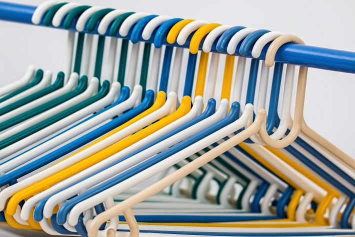 Coat hangers on a clothes rail in the wardrobe on-board a cruise ship