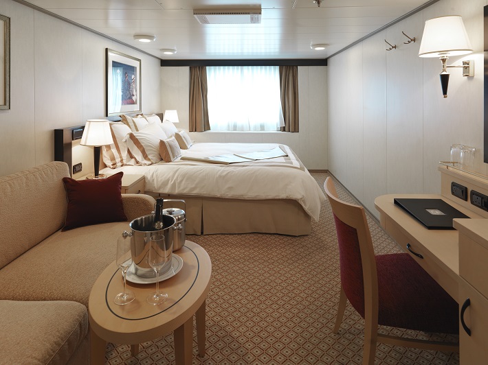 The sophisticated interior of an Oceanview room on-board a Cunard ship